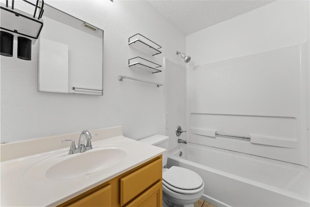 491 Emerald Fields Ln, Kyle, TX 78640 - full bathroom featuring toilet, a textured ceiling, bathing tub / shower combination, and vanity
