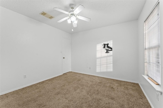 491 Emerald Fields Ln, Kyle, TX 78640 - carpeted empty room featuring a textured ceiling, ceiling fan, and baseboards