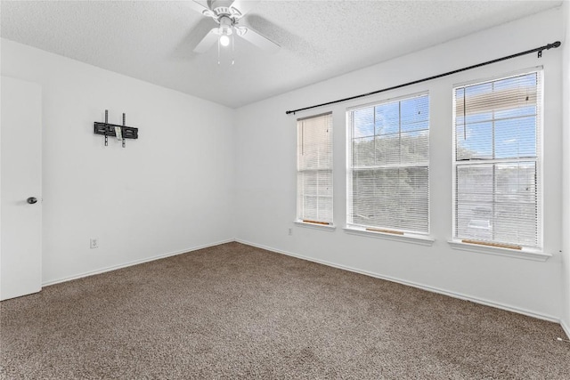 491 Emerald Fields Ln, Kyle, TX 78640 - spare room with carpet floors, ceiling fan, a textured ceiling, and baseboards