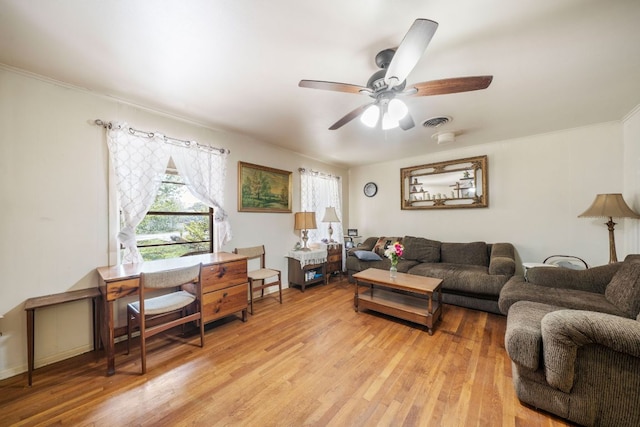 704 6th St, Blanco, TX 78606 - living room with light wood-style flooring, a ceiling fan, and ornamental molding