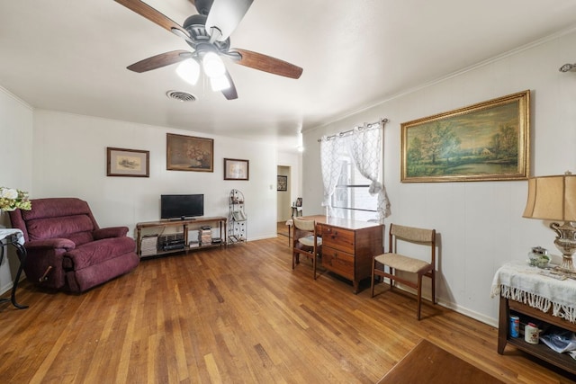704 6th St, Blanco, TX 78606 - living room with light wood finished floors, ceiling fan, crown molding, and baseboards