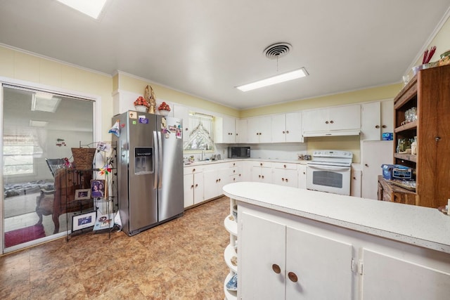 704 6th St, Blanco, TX 78606 - kitchen with stainless steel fridge with ice dispenser, white electric range, black microwave, light countertops, and a sink