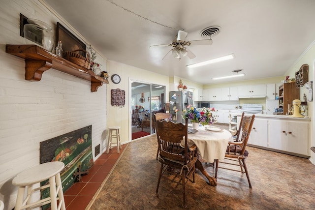 704 6th St, Blanco, TX 78606 - dining space featuring ornamental molding, ceiling fan, and a tile fireplace