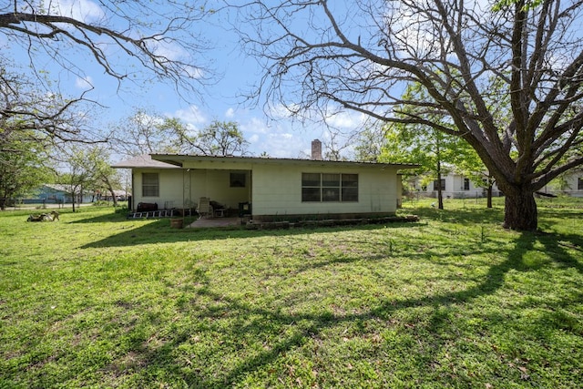 704 6th St, Blanco, TX 78606 - rear view of house featuring a chimney and a patio area