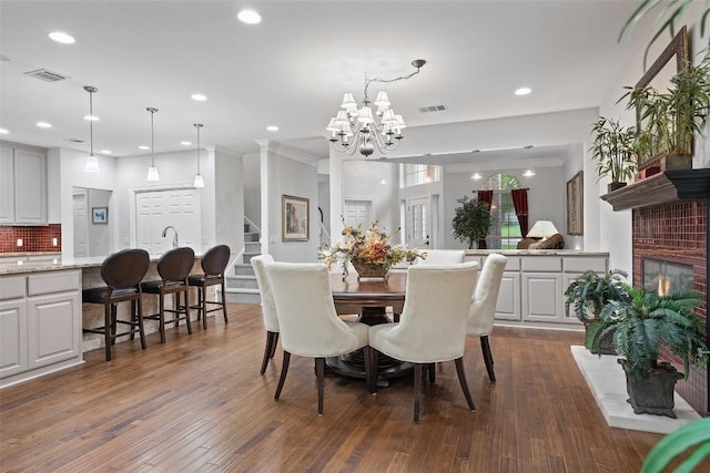 2603 Pearce Rd, Austin, TX 78730 - dining space featuring a chandelier, recessed lighting, dark wood-style flooring, crown molding, and stairway