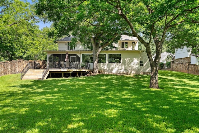 2603 Pearce Rd, Austin, TX 78730 - rear view of property featuring a sunroom, a lawn, stairs, and a wooden deck
