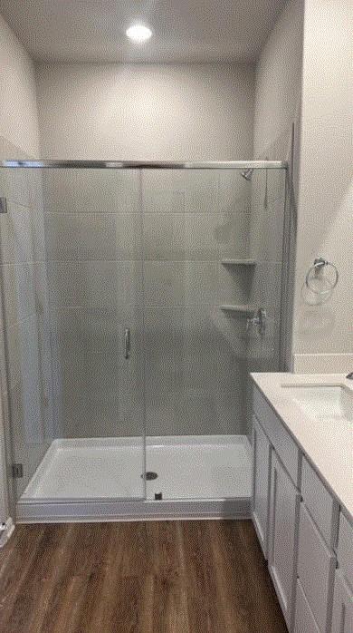 1020 Vista View Dr Unit 2001, Georgetown, TX 78626 - bathroom with wood finished floors, a shower stall, and vanity