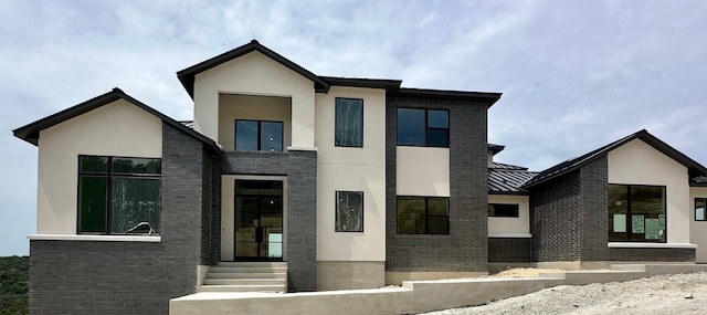 104 High View Trl, Lakeway, TX 78738 - view of front of home with stucco siding, brick siding, and a standing seam roof