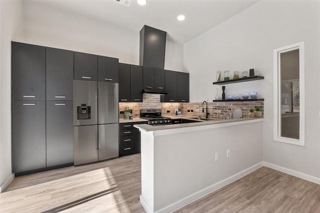 4510 Terry-O Ln Unit 108, Austin, TX 78745 - kitchen with stainless steel appliances, dark cabinetry, light wood-type flooring, open shelves, and recessed lighting