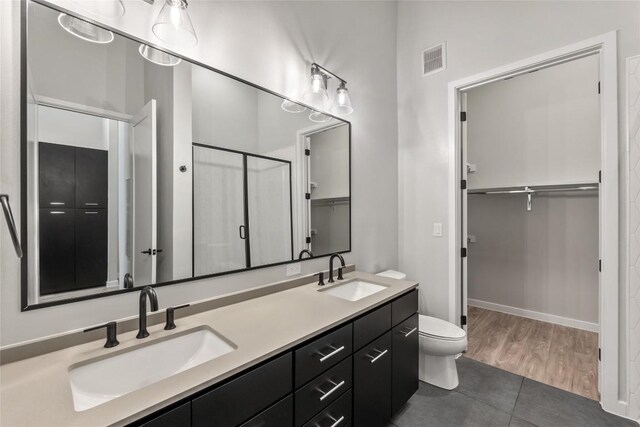 4510 Terry-O Ln Unit 108, Austin, TX 78745 - full bath with a walk in closet, a shower stall, double vanity, tile patterned flooring, and toilet