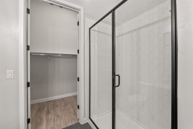 4510 Terry-O Ln Unit 108, Austin, TX 78745 - bathroom with a stall shower, wood finished floors, and a spacious closet