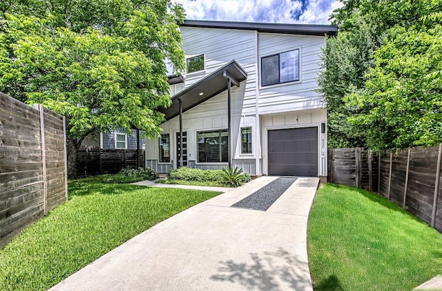 600 Blackson Ave Unit 2, Austin, TX 78752 - view of front of home featuring concrete driveway, board and batten siding, and a garage