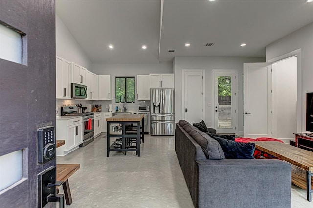 600 Blackson Ave Unit 2, Austin, TX 78752 - living room featuring concrete floors and recessed lighting