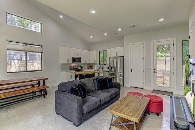 600 Blackson Ave Unit 2, Austin, TX 78752 - living room featuring baseboards, recessed lighting, plenty of natural light, and high vaulted ceiling