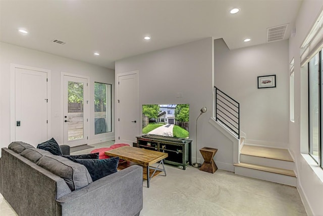 600 Blackson Ave Unit 2, Austin, TX 78752 - living room with plenty of natural light, recessed lighting, light colored carpet, stairs, and baseboards