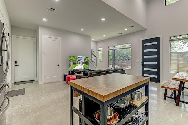 600 Blackson Ave Unit 2, Austin, TX 78752 - kitchen featuring recessed lighting, healthy amount of natural light, concrete flooring, and freestanding refrigerator