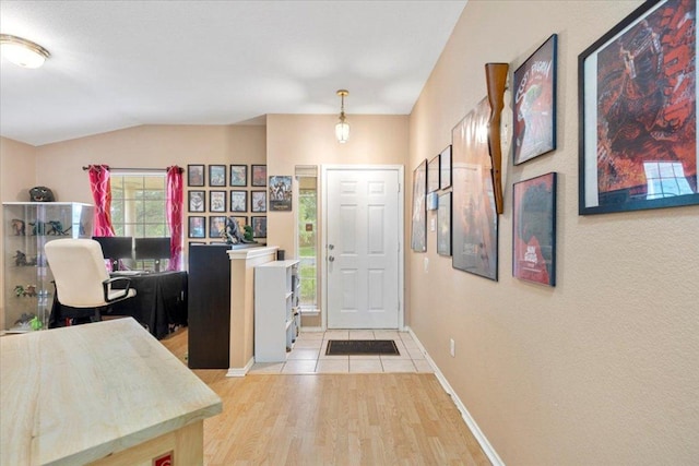 4125 Licorice Ln, Austin, TX 78728 - entryway with light wood-style floors, baseboards, and lofted ceiling
