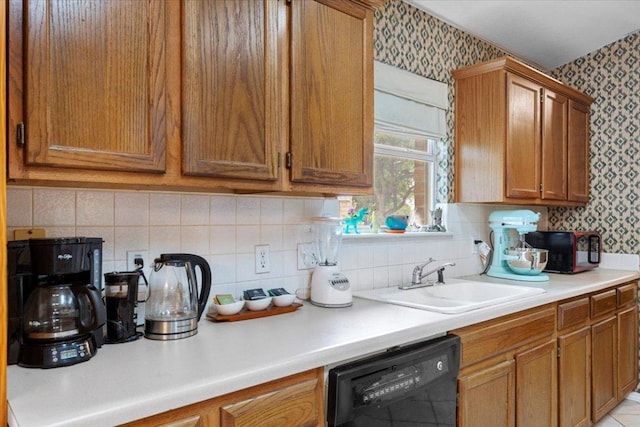 4125 Licorice Ln, Austin, TX 78728 - kitchen featuring black appliances, wallpapered walls, brown cabinetry, light countertops, and tasteful backsplash