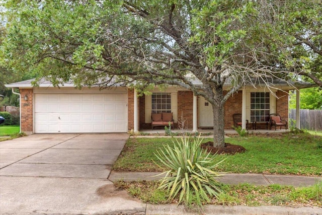 4125 Licorice Ln, Austin, TX 78728 - view of property hidden behind natural elements with brick siding, concrete driveway, and an attached garage