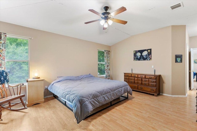 4125 Licorice Ln, Austin, TX 78728 - bedroom featuring wood finished floors, vaulted ceiling, multiple windows, baseboards, and ceiling fan