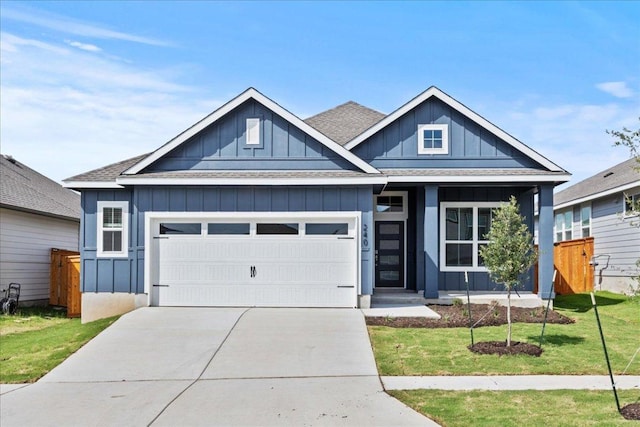 240 Camino Verde Dr, San Marcos, TX 78666 - view of front of house with an attached garage, board and batten siding, concrete driveway, and roof with shingles