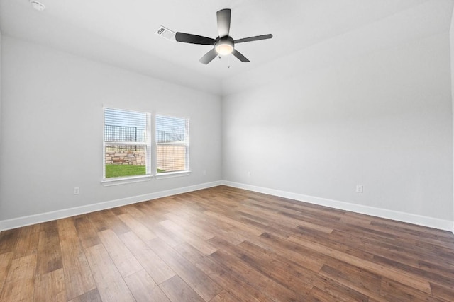 9708 Gladsome Path, Manor, TX 78653 - spare room featuring dark wood finished floors, baseboards, and a ceiling fan