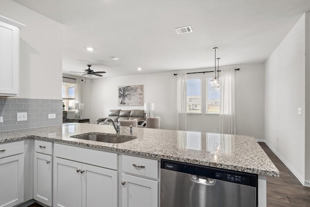 110 Saide St, Georgetown, TX 78626 - kitchen with stainless steel dishwasher, a sink, dark wood finished floors, open floor plan, and white cabinetry