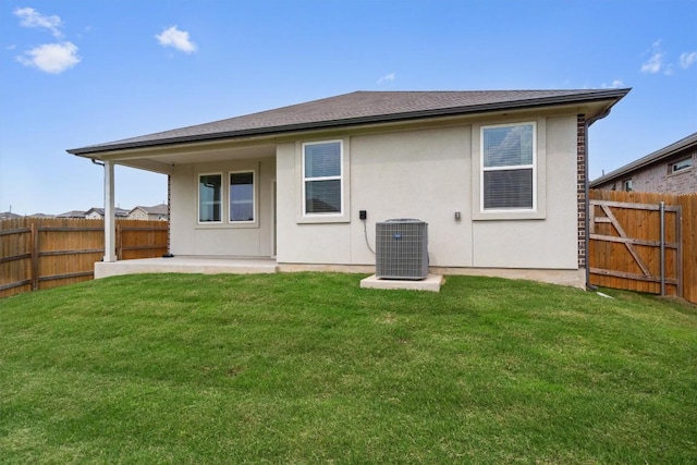 110 Saide St, Georgetown, TX 78626 - rear view of house featuring central AC, stucco siding, and a patio area