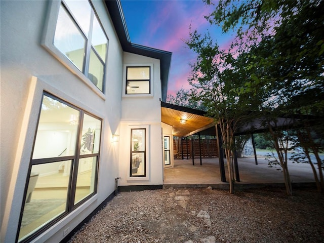 2004 N Cuernavaca Dr, Austin, TX 78733 - property exterior at dusk featuring stucco siding and a patio