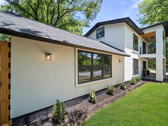 2004 N Cuernavaca Dr, Austin, TX 78733 - view of property exterior with a shingled roof, stucco siding, a lawn, and a balcony