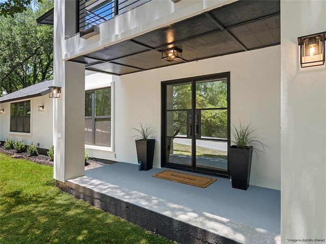 2004 N Cuernavaca Dr, Austin, TX 78733 - property entrance with french doors, stucco siding, and a yard