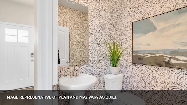 272 Morning Glory Loop, Kyle, TX 78640 - bathroom with wallpapered walls, a sink, and toilet