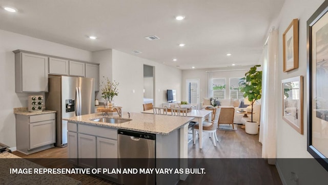 272 Morning Glory Loop, Kyle, TX 78640 - kitchen with gray cabinets, a sink, stainless steel appliances, light wood finished floors, and light stone countertops