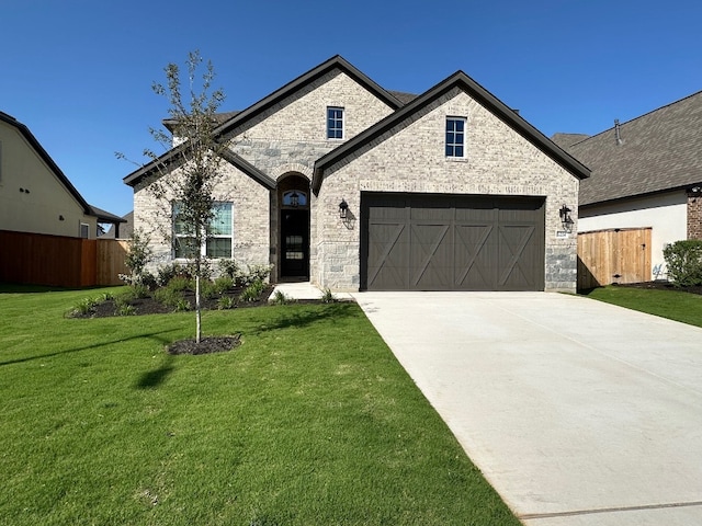 17224 Autumn Falls Dr, Manor, TX 78653 - french country inspired facade with driveway, brick siding, and an attached garage
