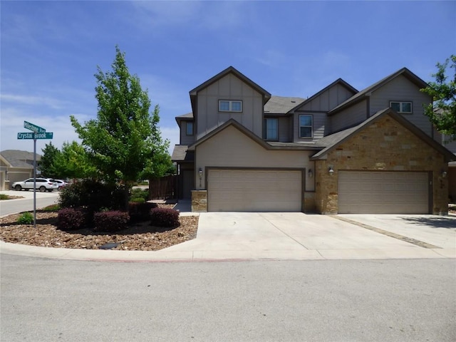 918 Crystal Brook Cv, New Braunfels, TX 78130 - view of front facade featuring board and batten siding, concrete driveway, and stone siding
