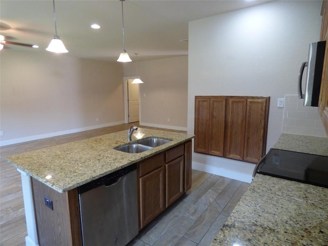 918 Crystal Brook Cv, New Braunfels, TX 78130 - kitchen featuring appliances with stainless steel finishes, a sink, an island with sink, pendant lighting, and light stone counters
