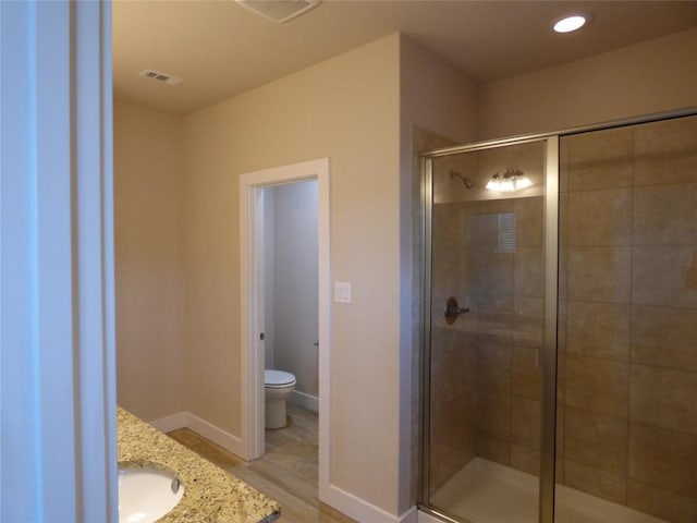 918 Crystal Brook Cv, New Braunfels, TX 78130 - full bathroom featuring a shower stall, toilet, wood finished floors, baseboards, and recessed lighting