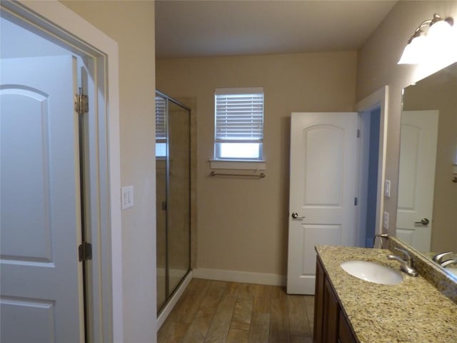 918 Crystal Brook Cv, New Braunfels, TX 78130 - bathroom with a shower stall, wood finished floors, vanity, and baseboards