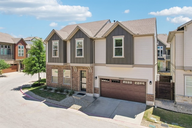 townhome / multi-family property with board and batten siding, an attached garage, driveway, brick siding, and a shingled roof