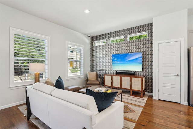 living area featuring baseboards, wood-type flooring, and recessed lighting