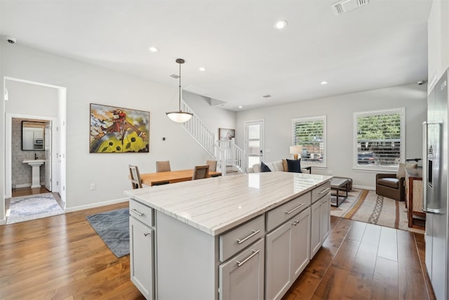 kitchen with a kitchen island, light wood-style flooring, decorative light fixtures, baseboards, and recessed lighting