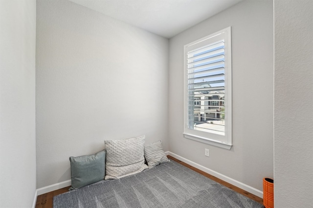 living area featuring wood finished floors and baseboards