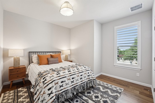 bedroom featuring wood finished floors and baseboards