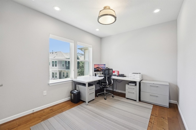 office featuring light wood-type flooring, baseboards, and recessed lighting