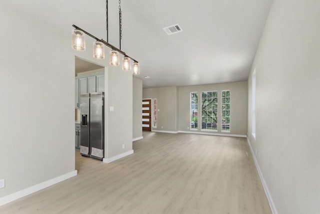 7057 Thistle Hill Way, Austin, TX 78754 - unfurnished living room with light wood finished floors and baseboards