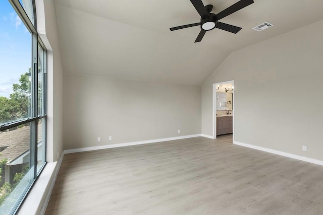 7057 Thistle Hill Way, Austin, TX 78754 - unfurnished room featuring vaulted ceiling, a ceiling fan, light wood-type flooring, baseboards, and a chandelier