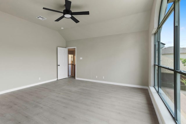 7057 Thistle Hill Way, Austin, TX 78754 - spare room with vaulted ceiling, wood finished floors, a ceiling fan, and baseboards