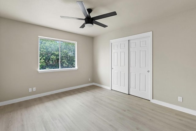 7057 Thistle Hill Way, Austin, TX 78754 - unfurnished bedroom featuring wood finished floors, a closet, baseboards, and ceiling fan