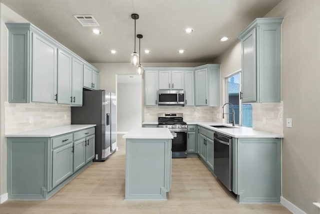 7057 Thistle Hill Way, Austin, TX 78754 - kitchen with stainless steel appliances, a sink, a kitchen island, tasteful backsplash, and recessed lighting