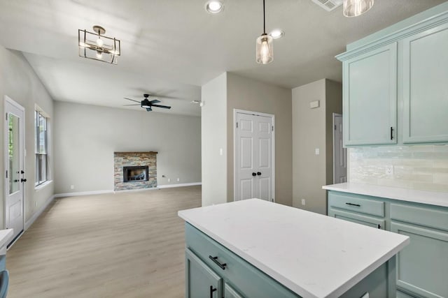 7057 Thistle Hill Way, Austin, TX 78754 - kitchen featuring a ceiling fan, decorative backsplash, light wood finished floors, light countertops, and recessed lighting